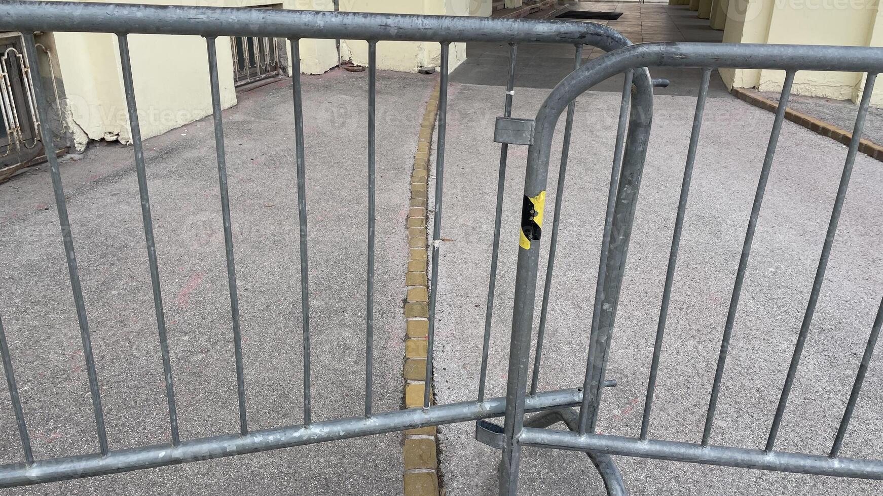 Barrier blocking pathway near historic building in city photo
