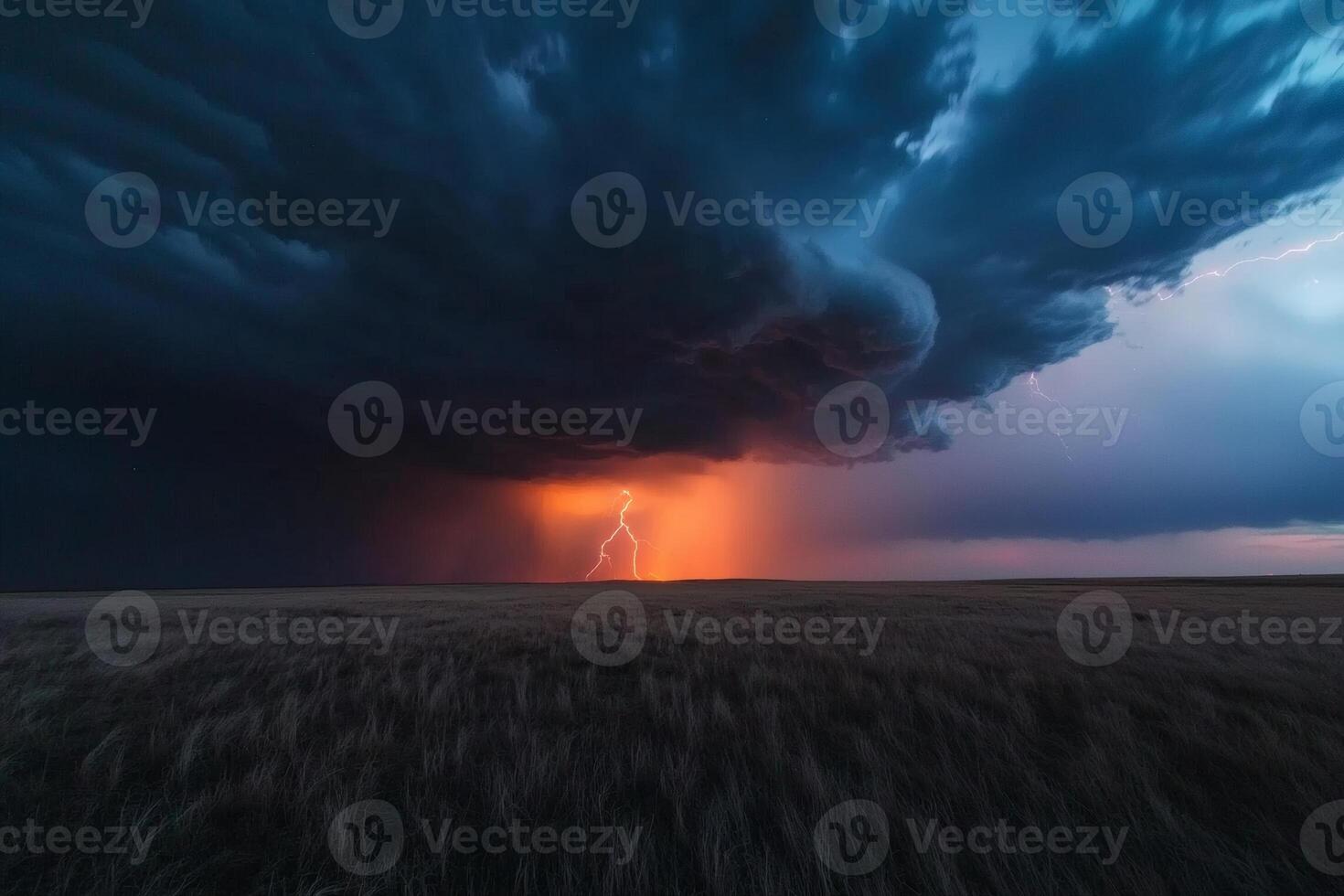 Majestic tornado spins under the night sky illuminated by flashes of lightning in a dramatic display of nature's power photo