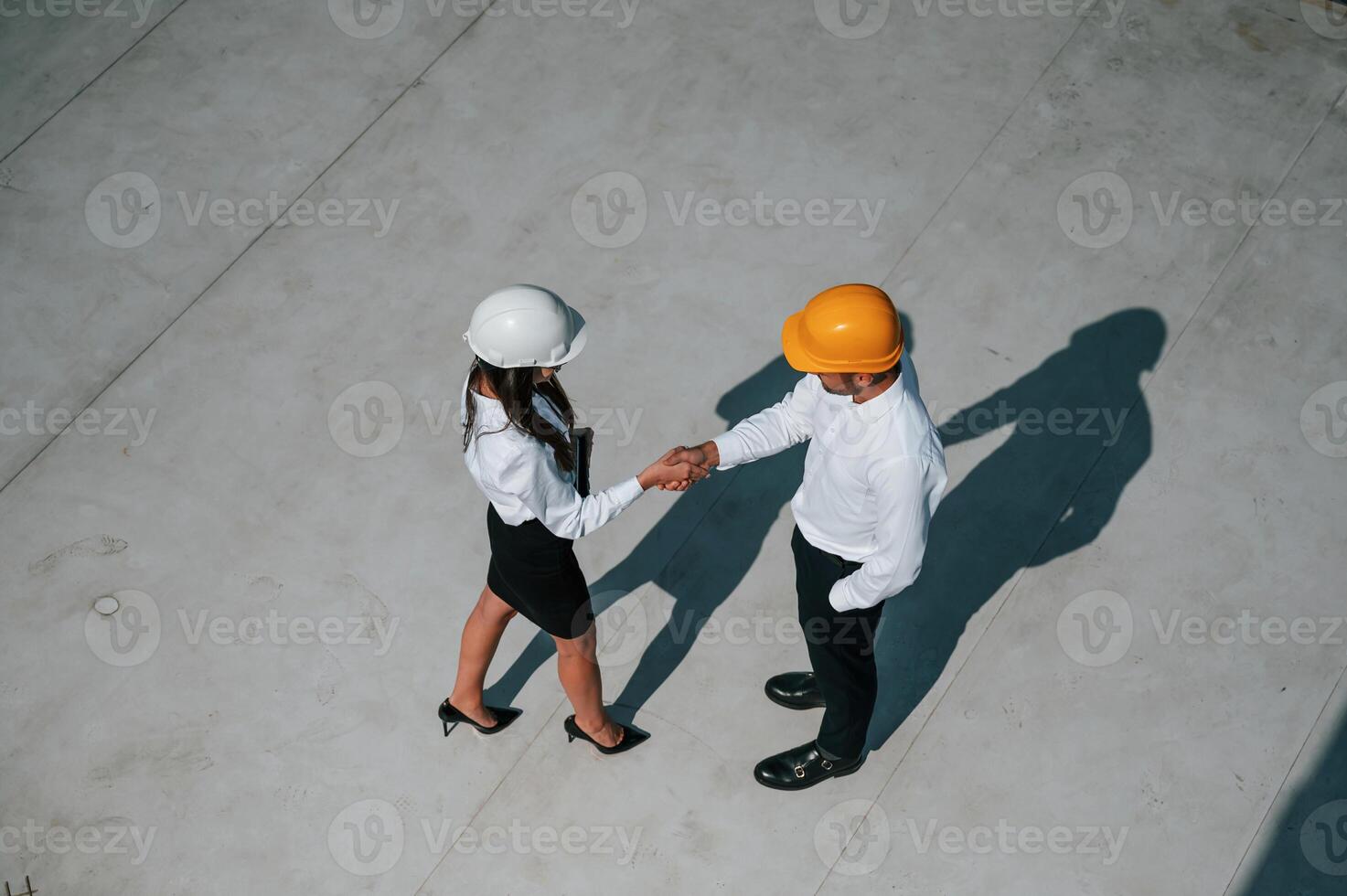 Successfu,l deal, doing, handshake. Man with woman are working on the construction project together outside photo