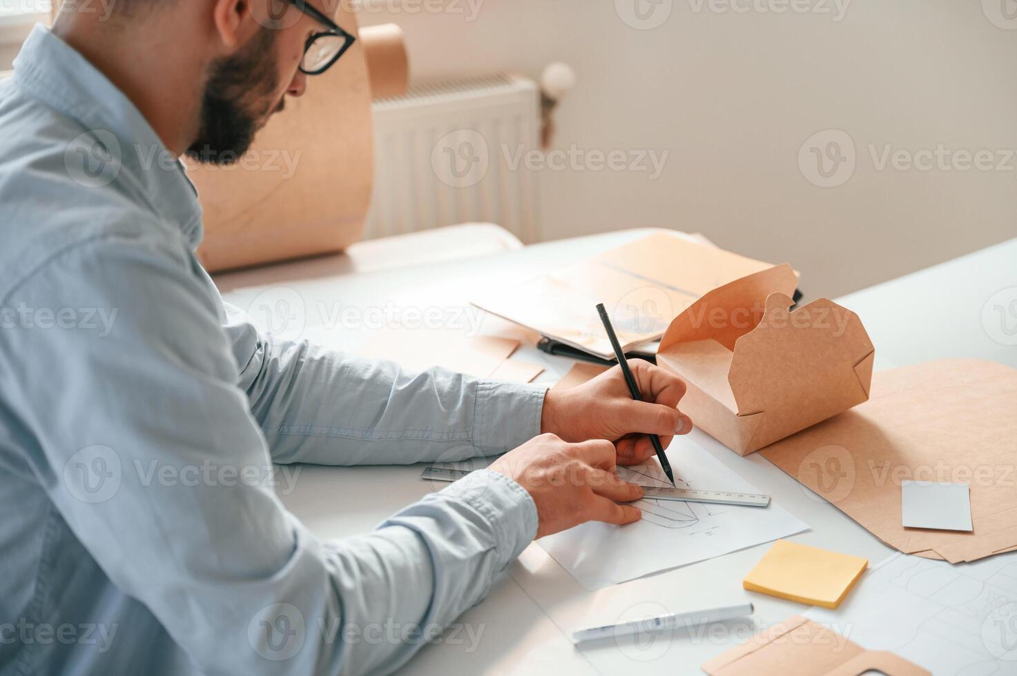 Drawing ,process. Print house worker in white clothes is indoors photo