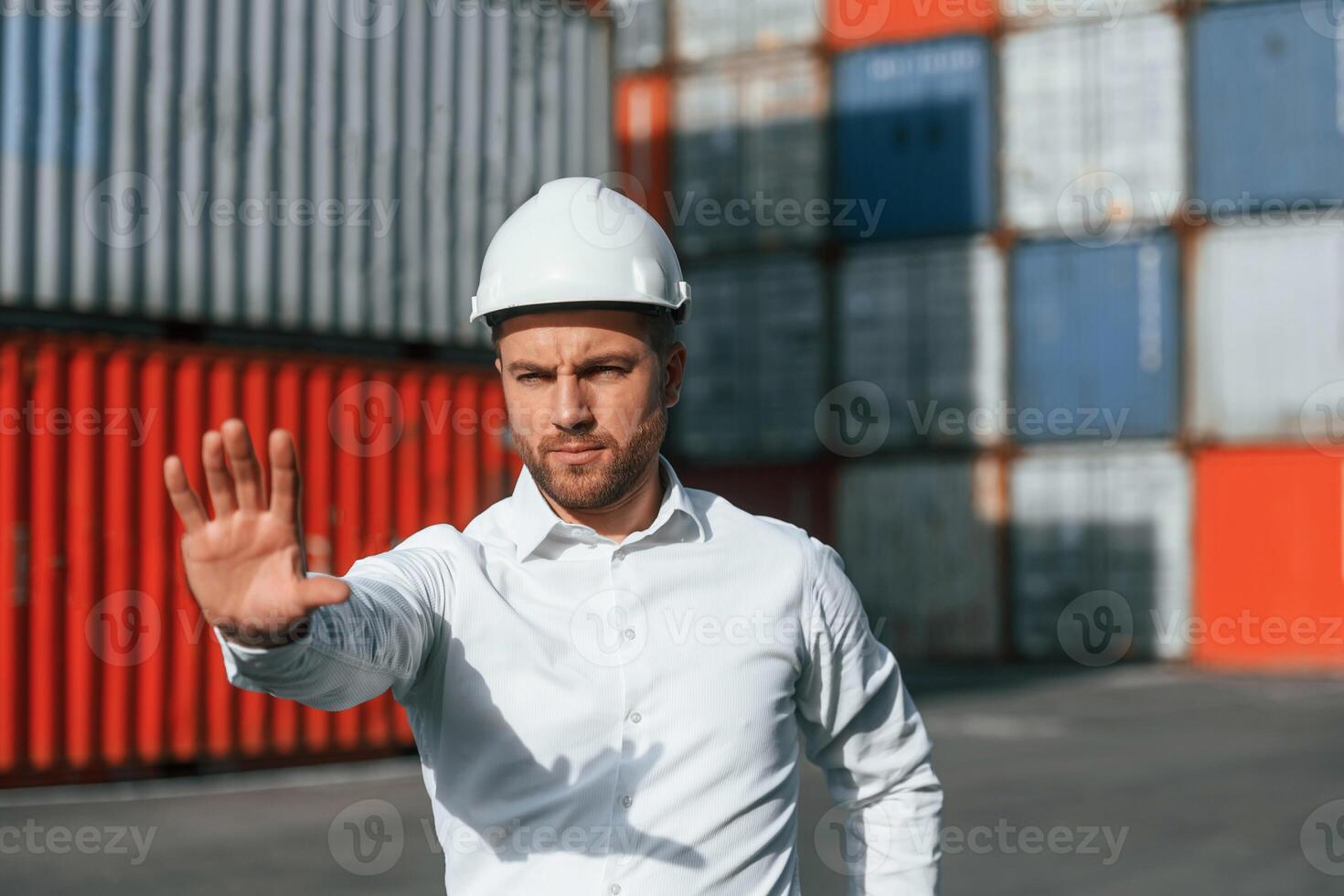Restricted area. No,trespassing. Male worker is on the location with containers photo