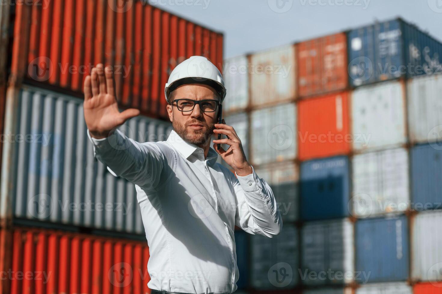 Restricted, area. No trespassing. Male worker is on the location with containers photo