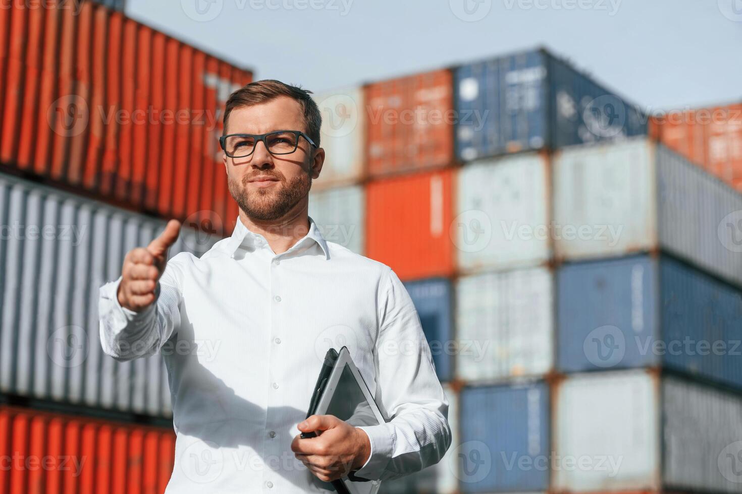 Giving, hand to make handshake, successful deal. Male worker is on the location with containers photo