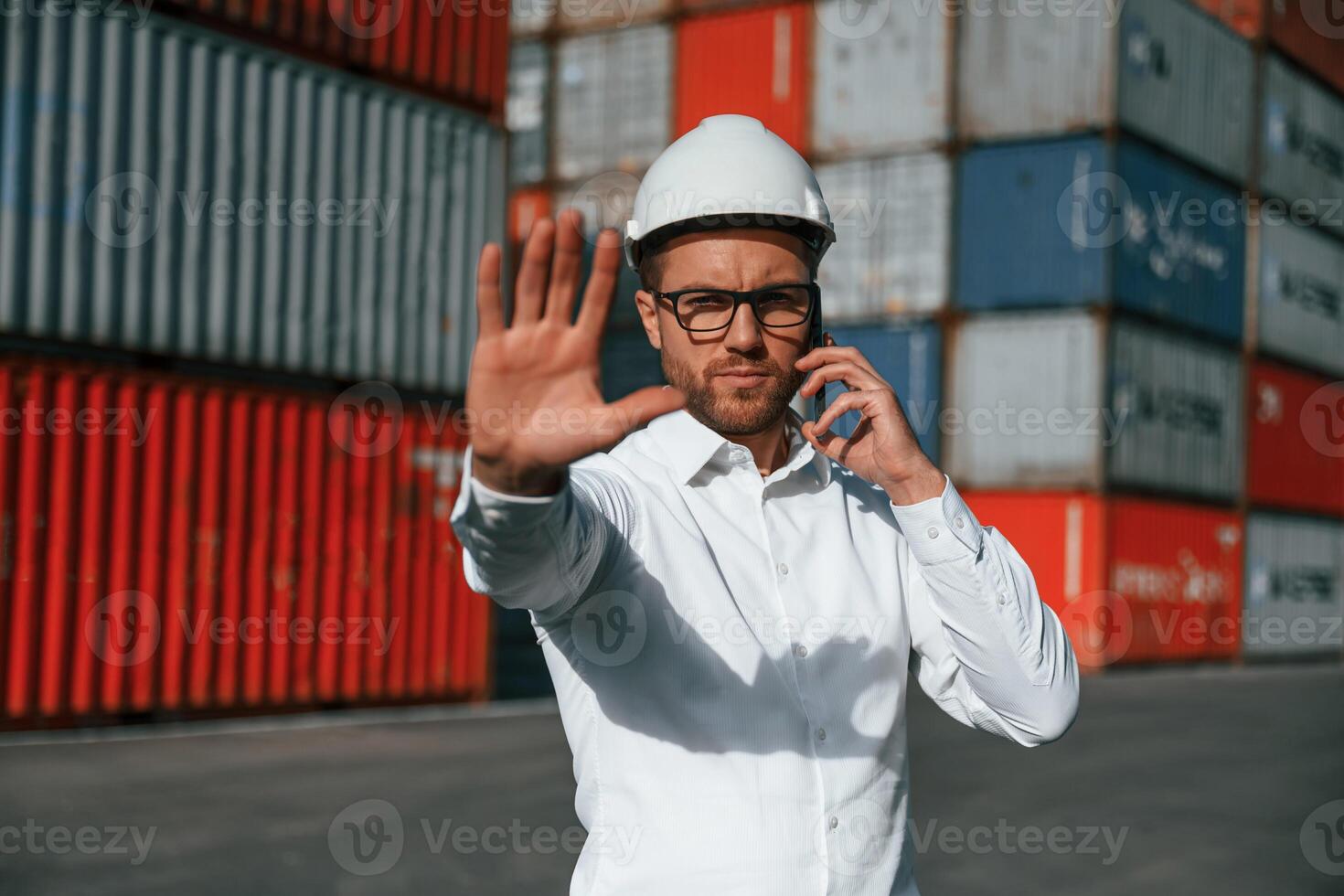 Restricted area... No trespassing. Male worker is on the location with containers photo
