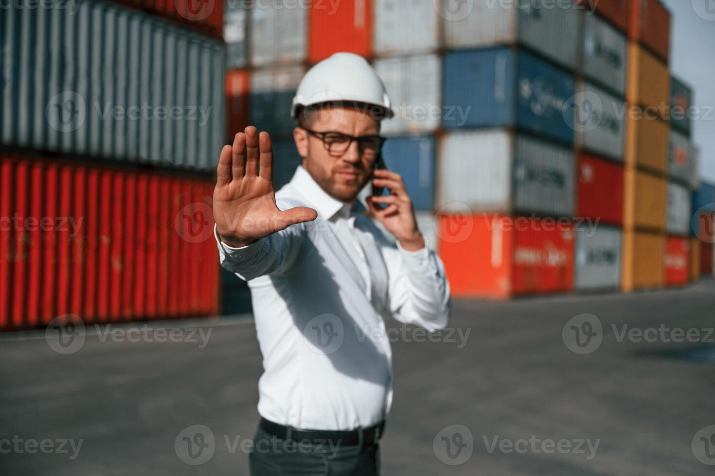No trespassing. Area is closed. Male worker is ,on the location with containers photo