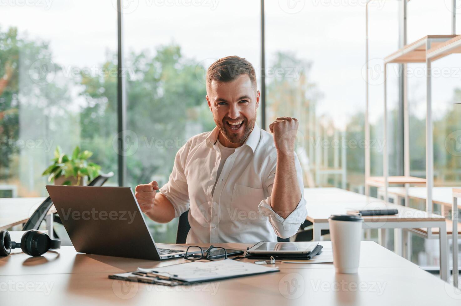 Successful project. Concept ,of, celebration and happiness. Man in formal clothes is working in the modern office photo