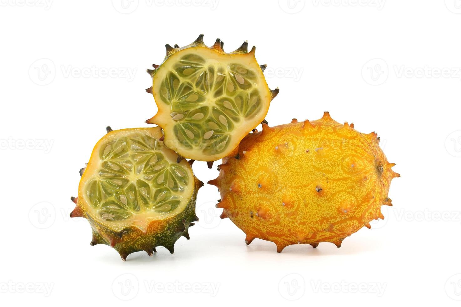 Closeup of vibrant kiwano horned melon with whole and sliced fruit on white background photo