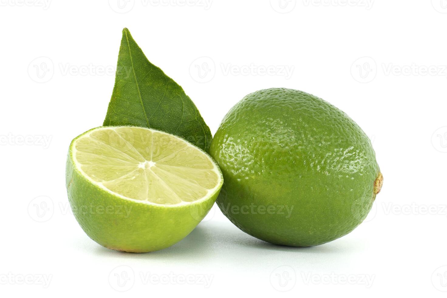 Lime cut in half showing pulp and leaf on white background photo