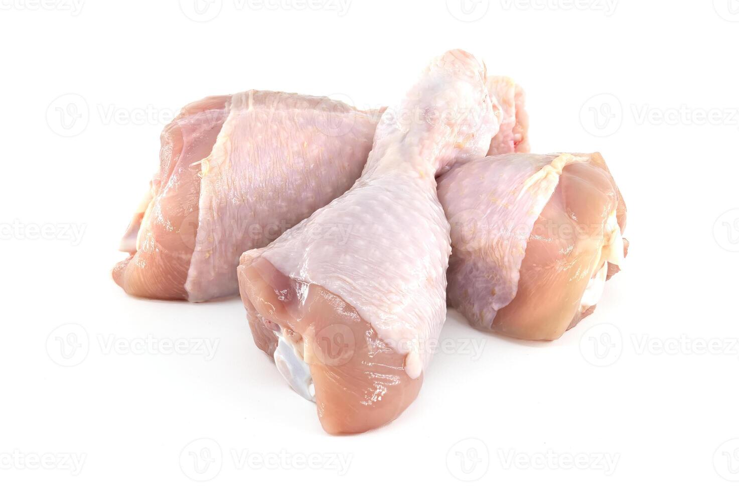 Raw chicken drumsticks isolated on white background photo