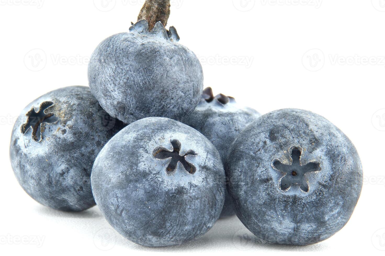 A vibrant macro shot captures the exquisite detail of a cluster of fresh blueberries. photo