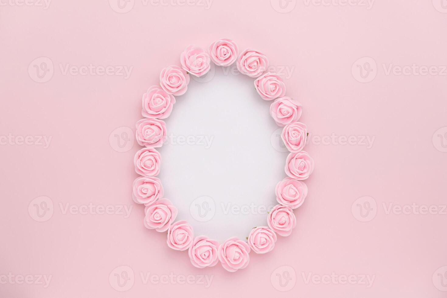 Pastel rosebuds egg shape on pink background. Versatile Easter-themed composition perfect for backgrounds, greeting cards, social media, and seasonal marketing. photo