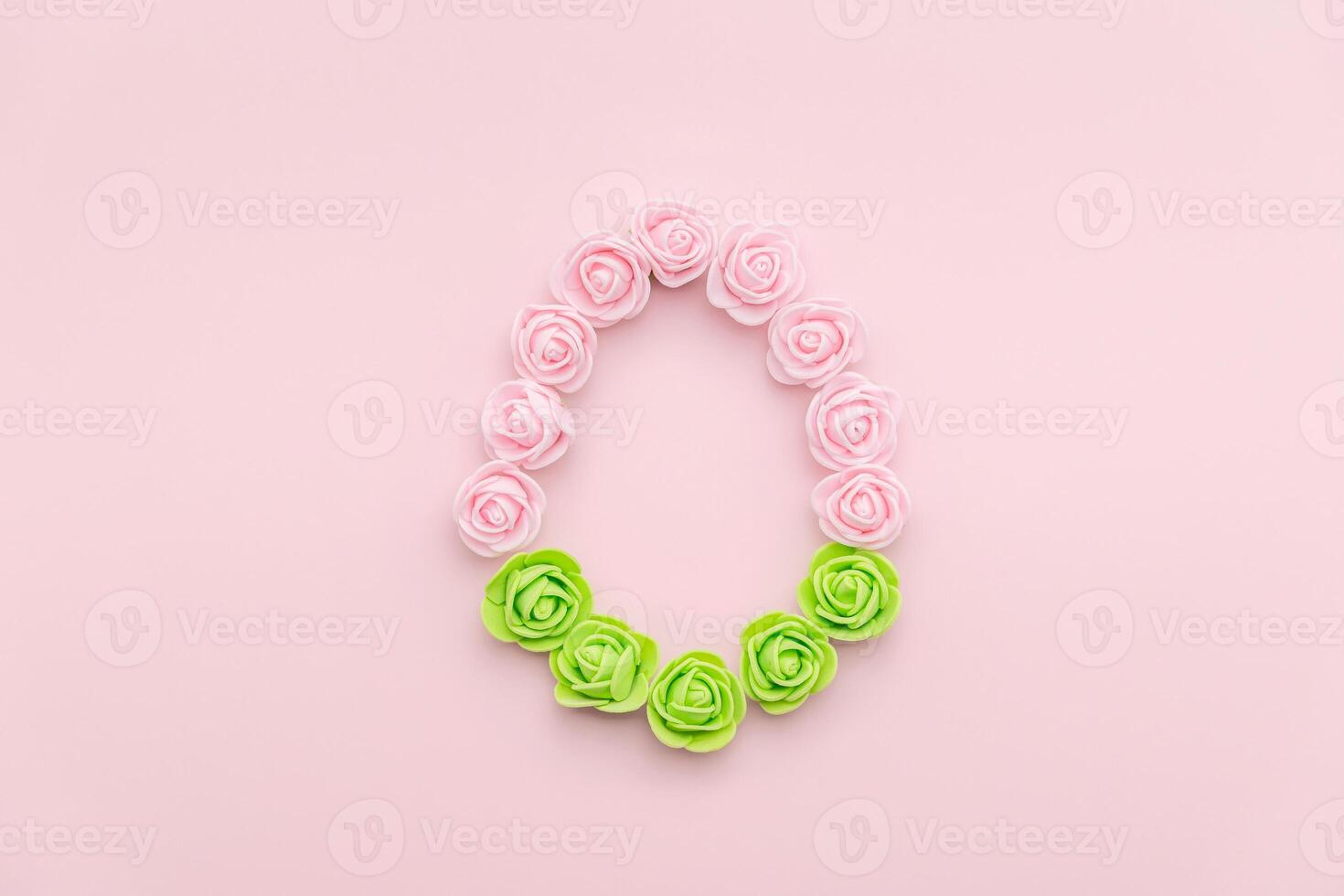 Rosebuds egg shape on pink background with green bottom photo