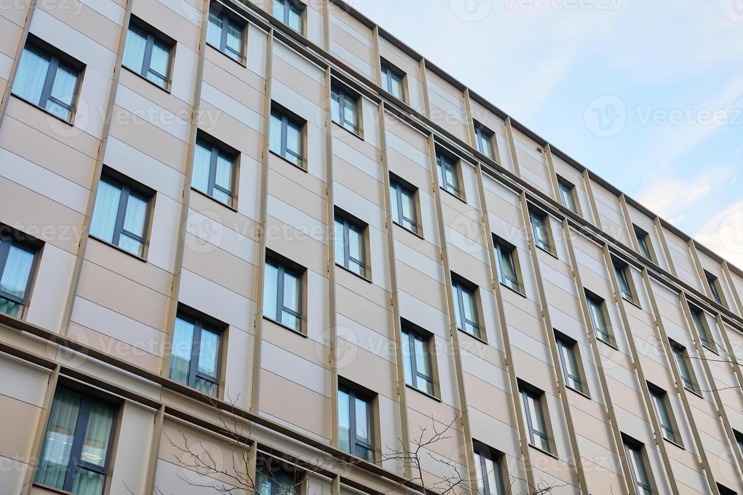 Modern office building with glass windows in geometric pattern photo