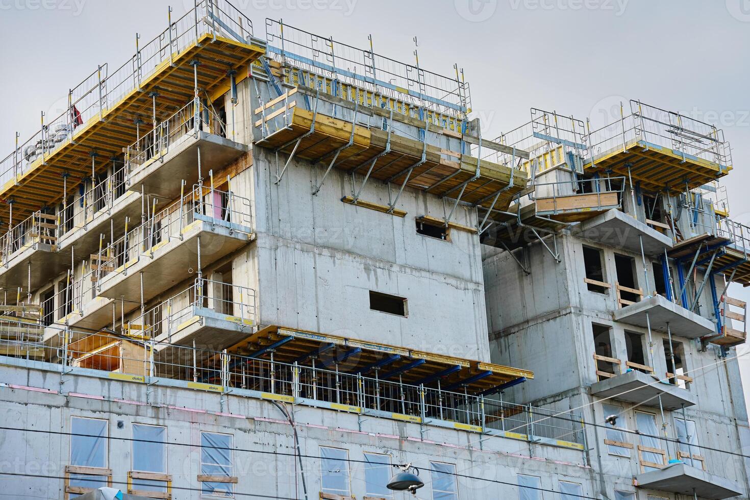 Modern building under construction with scaffolding photo