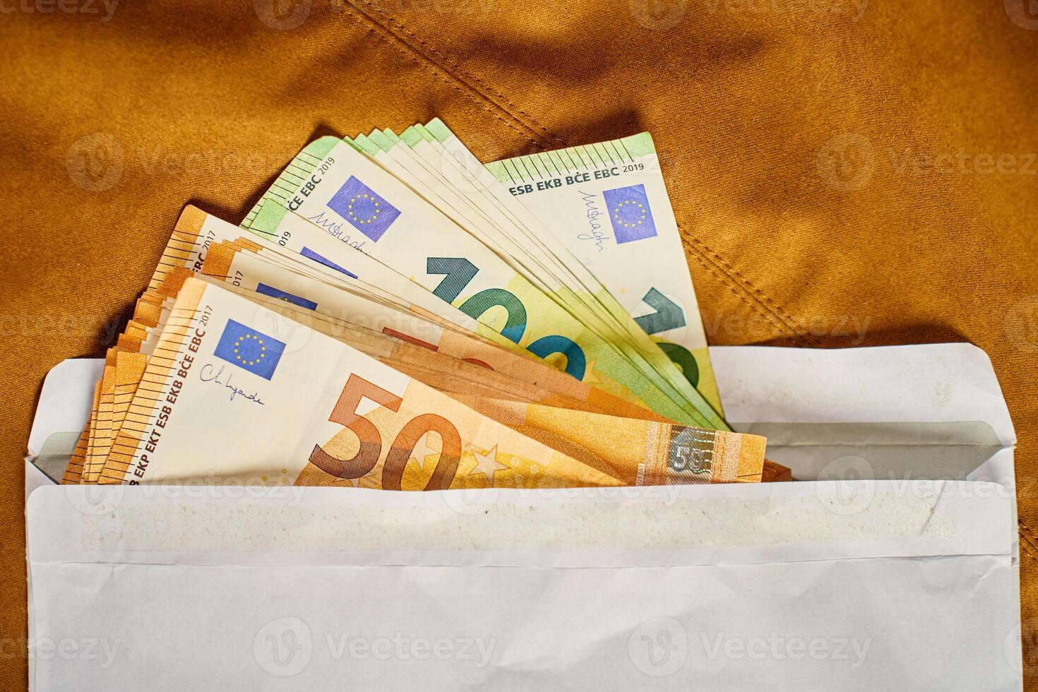 Euro banknotes in open envelope. Corruption and illegal cash payments photo