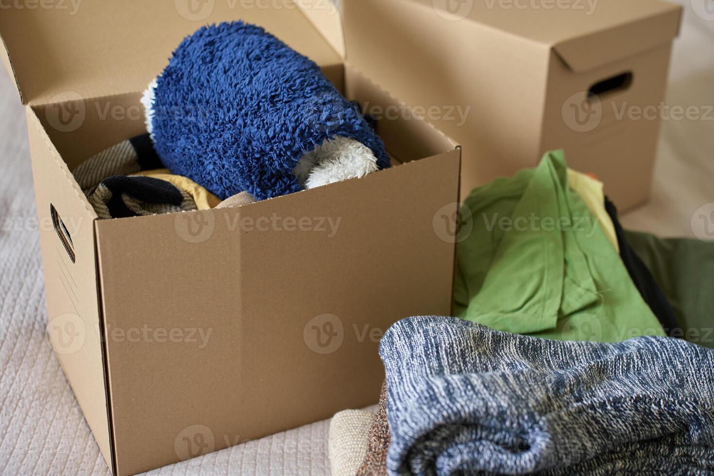 Boxes of Donated Clothes for Charity in Bedroom photo