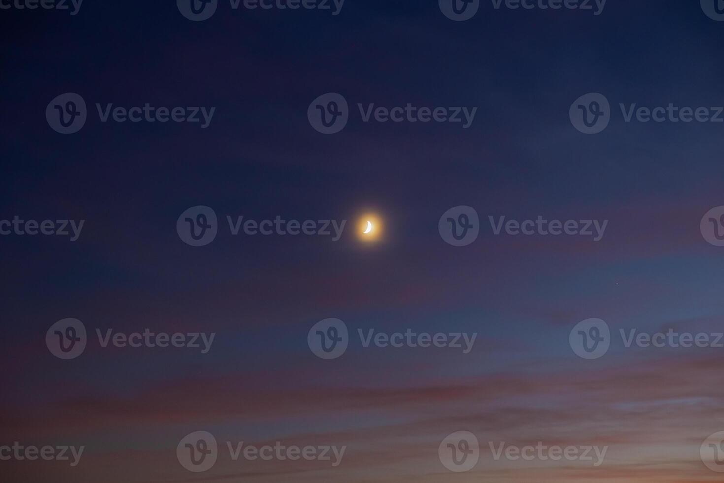 Crescent moon on the hazy sky. photo
