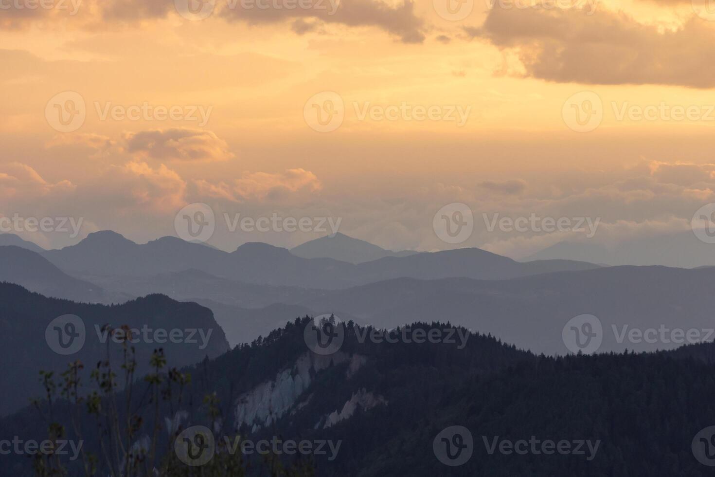Mountain range with mist and partly cloudy sky. Landscape backdrop photo