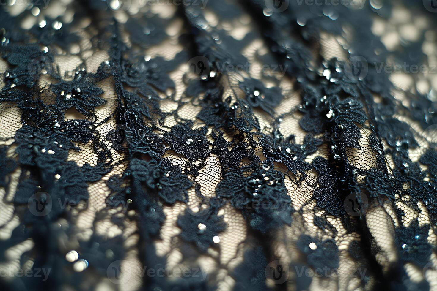 Close-up of black lace texture, a fine open fabric made by looping, twisting, or knitting thread into intricate patterns photo