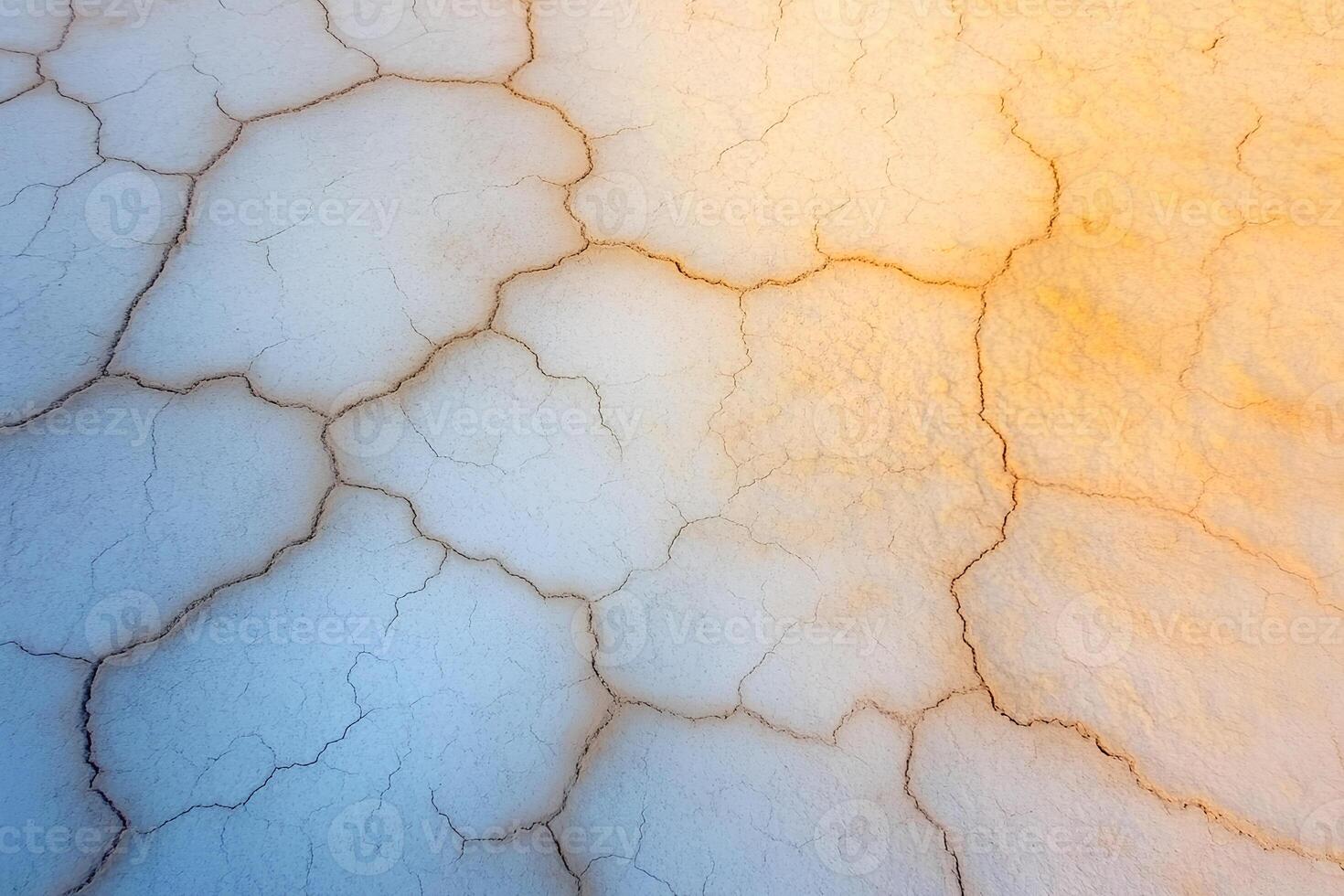A striking view of a dried lake in Yellowstone National Park, showcasing cracked earth, mineral deposits, and a unique natural landscape in Wyoming, USA photo