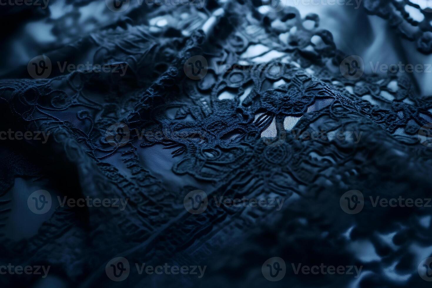 Close-up macro shot of black lace lingerie placed on a blue background, highlighting the intricate lace details and fine fabric photo