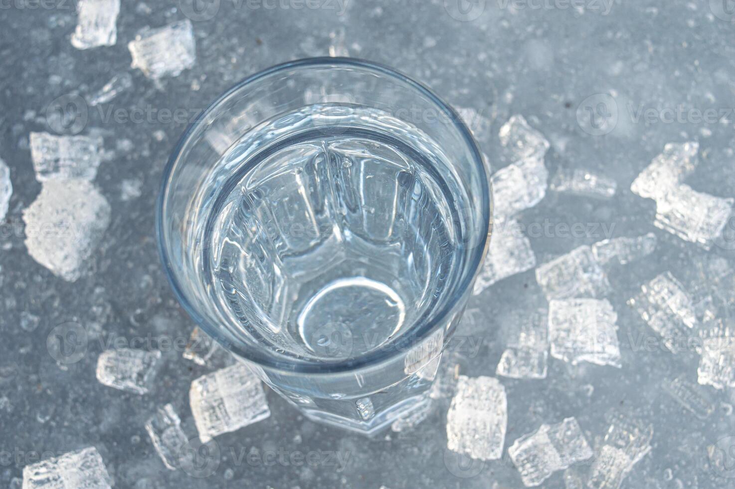 Beautiful transparent different pieces of ice on the ice surface. Pieces of ice filled with bubbles, a solid background. dishes, frozen water is clean. High quality photo
