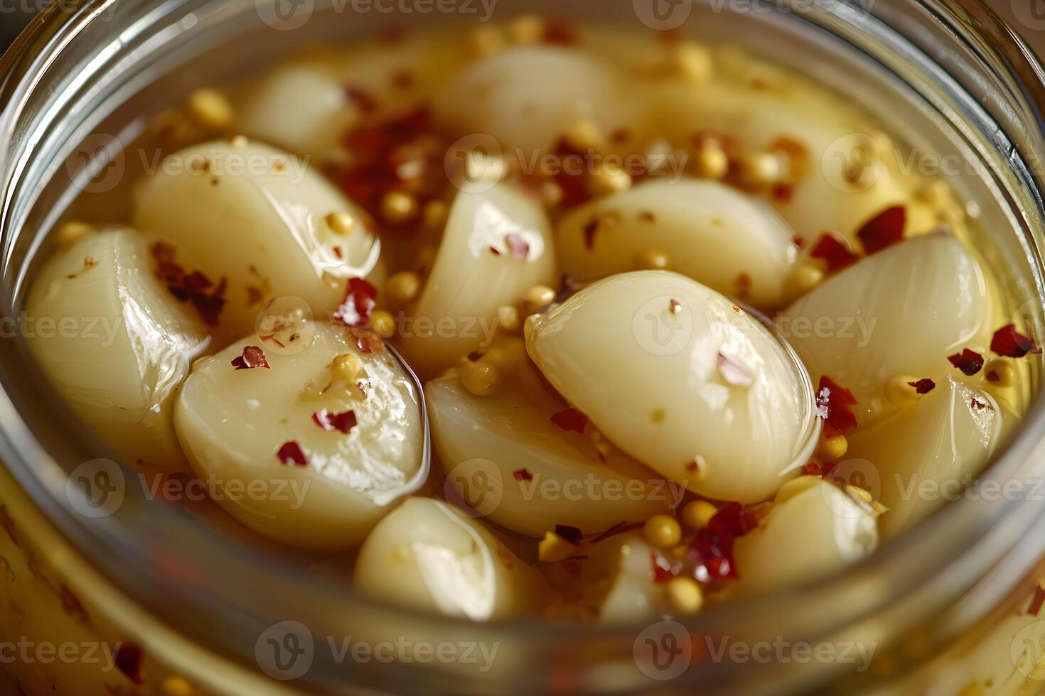 Pickled garlic cloves in tangy brine with spices, showcasing their glossy texture and vibrant colors photo