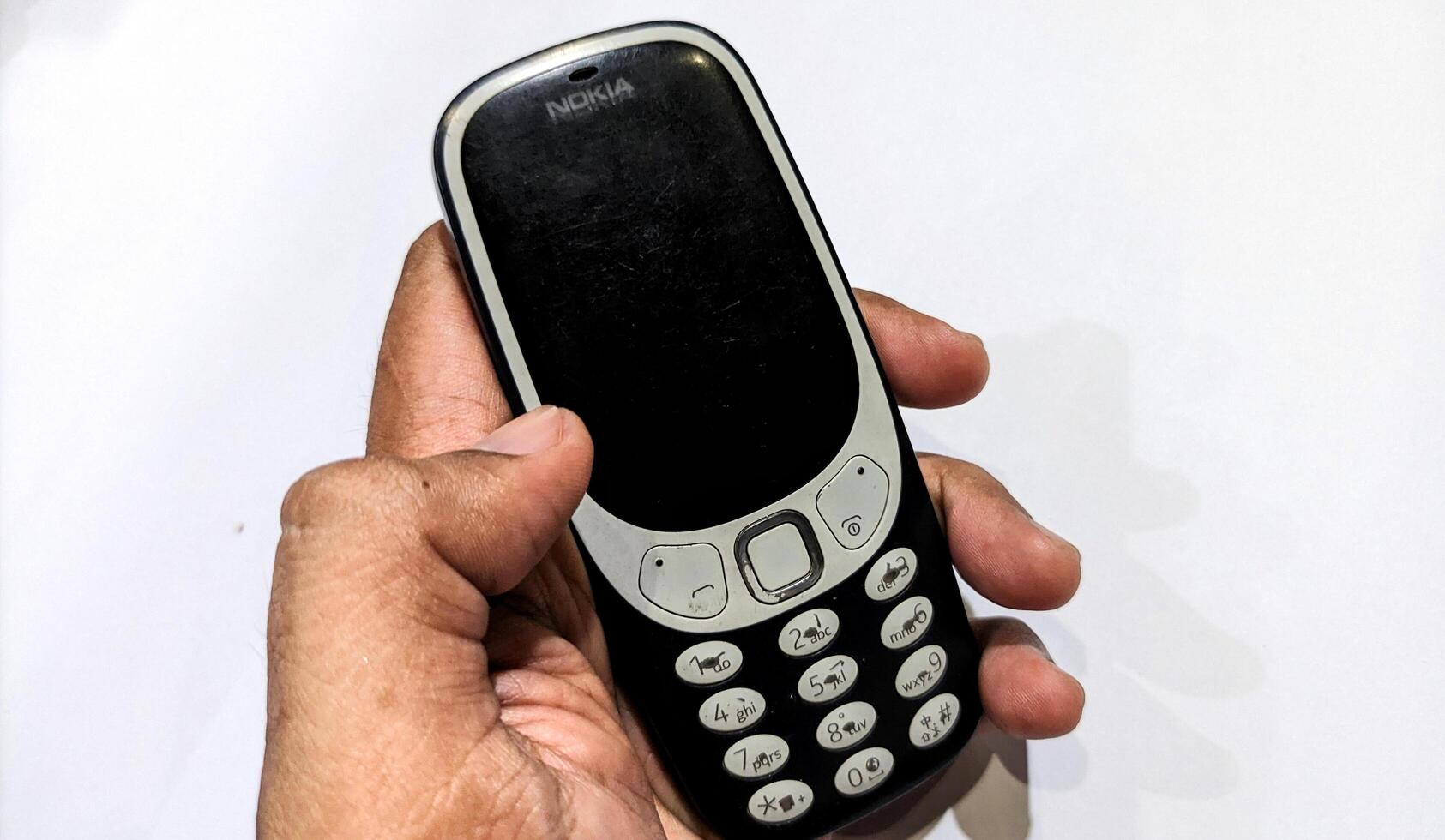 Indonesia, March 5 2025 - Close up of Nokia 3310 or Nokia ta 1030 isolated on white background. Produced by Nokia Corporation in Finland. photo
