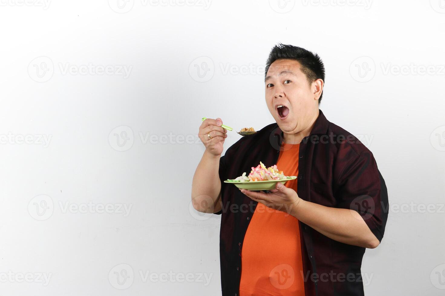 Man enjoying a delicious Indonesian Fried Rice with mouth open widely photo
