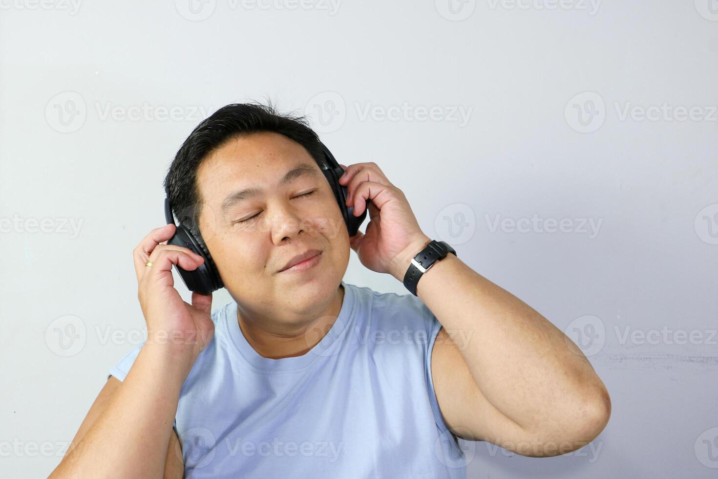 Man Enjoys Music with Eyes Closed to Relieve Stress photo
