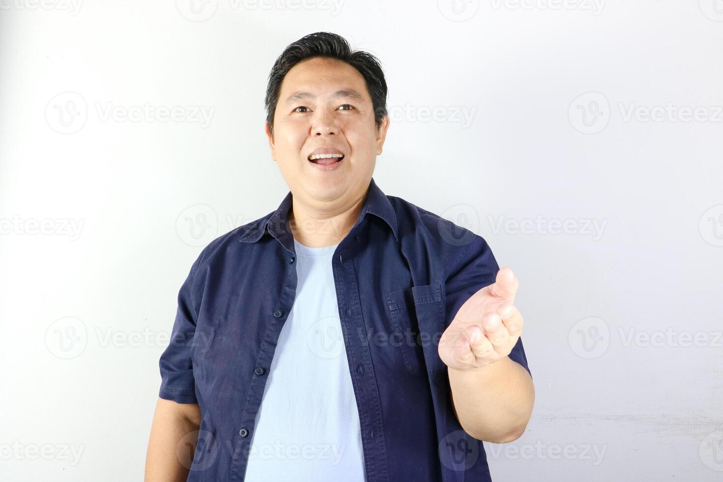 Friendly Man Gesturing with opened left hand as welcoming sign photo