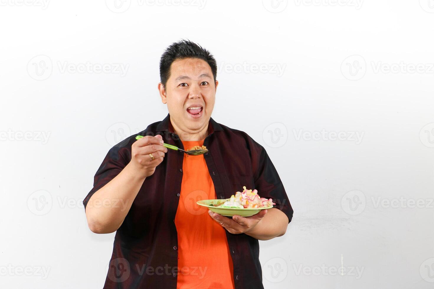 Man Enjoying Delicious Indonesian Fried Rice with face full of smile and happiness photo
