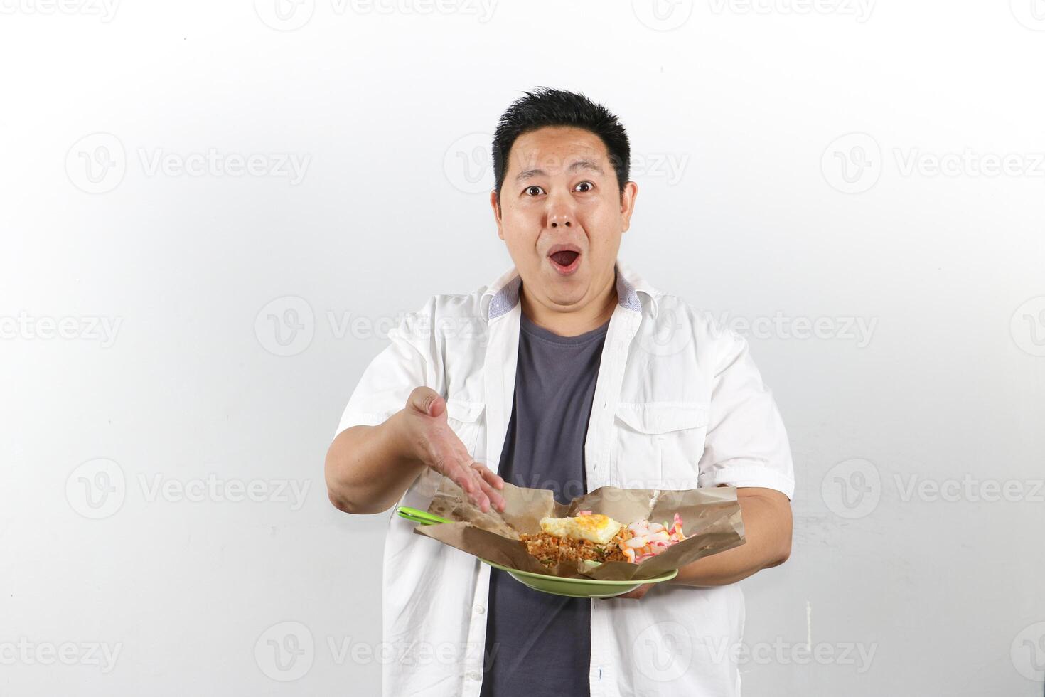 Shocked expression Man serving a plate of Indonesian Fried Rice photo