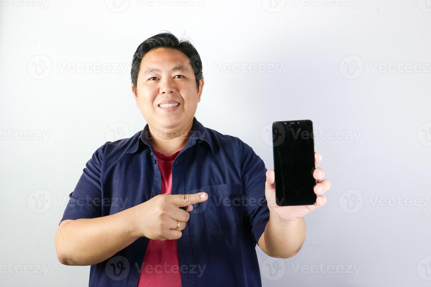 Man Showing Smartphone Screen and smiling very happy photo