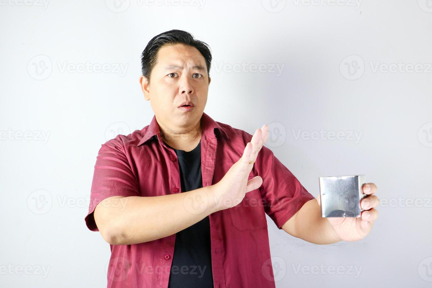 Refusal sign saying no and rejection gesture of man holding a stainless steel box photo