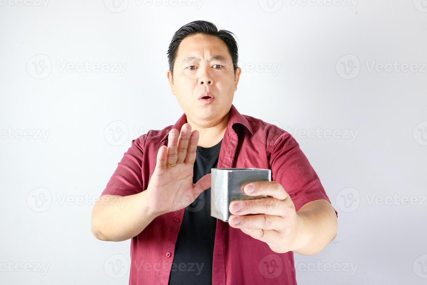 A man holding a stainless steel box and showing refusal sign, saying no and rejection gesture photo