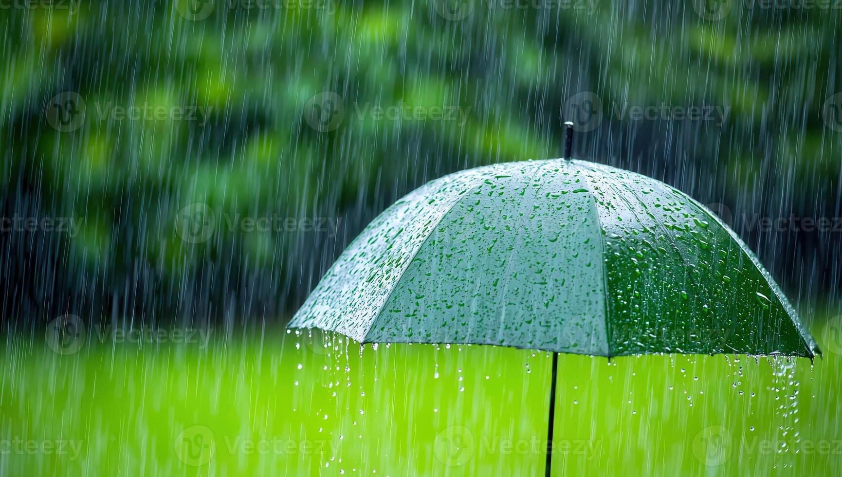 Green umbrella in torrential rain. Heavy rain and raindrops falling on an umbrella during a storm. Weather, season, and protection concepts. photo