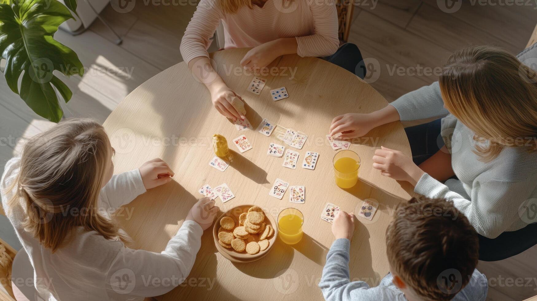 Four people playing cards at a table photo
