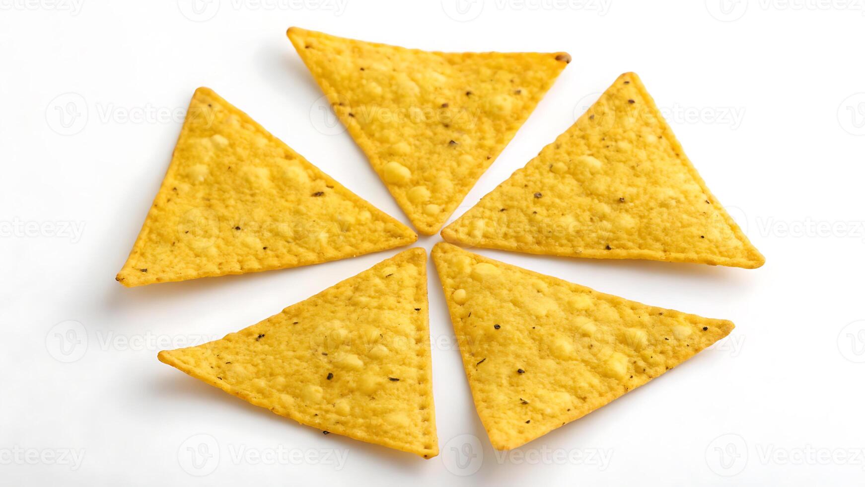 Triangular corn chips arranged in circular pattern perfect for snack time and party themes. photo