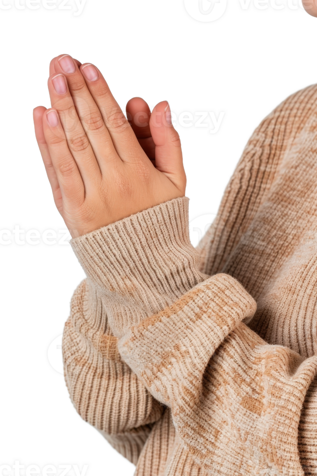 Person with clasped hands in a cozy beige sweater expressing gratitude and reflection in a warm, intimate setting png