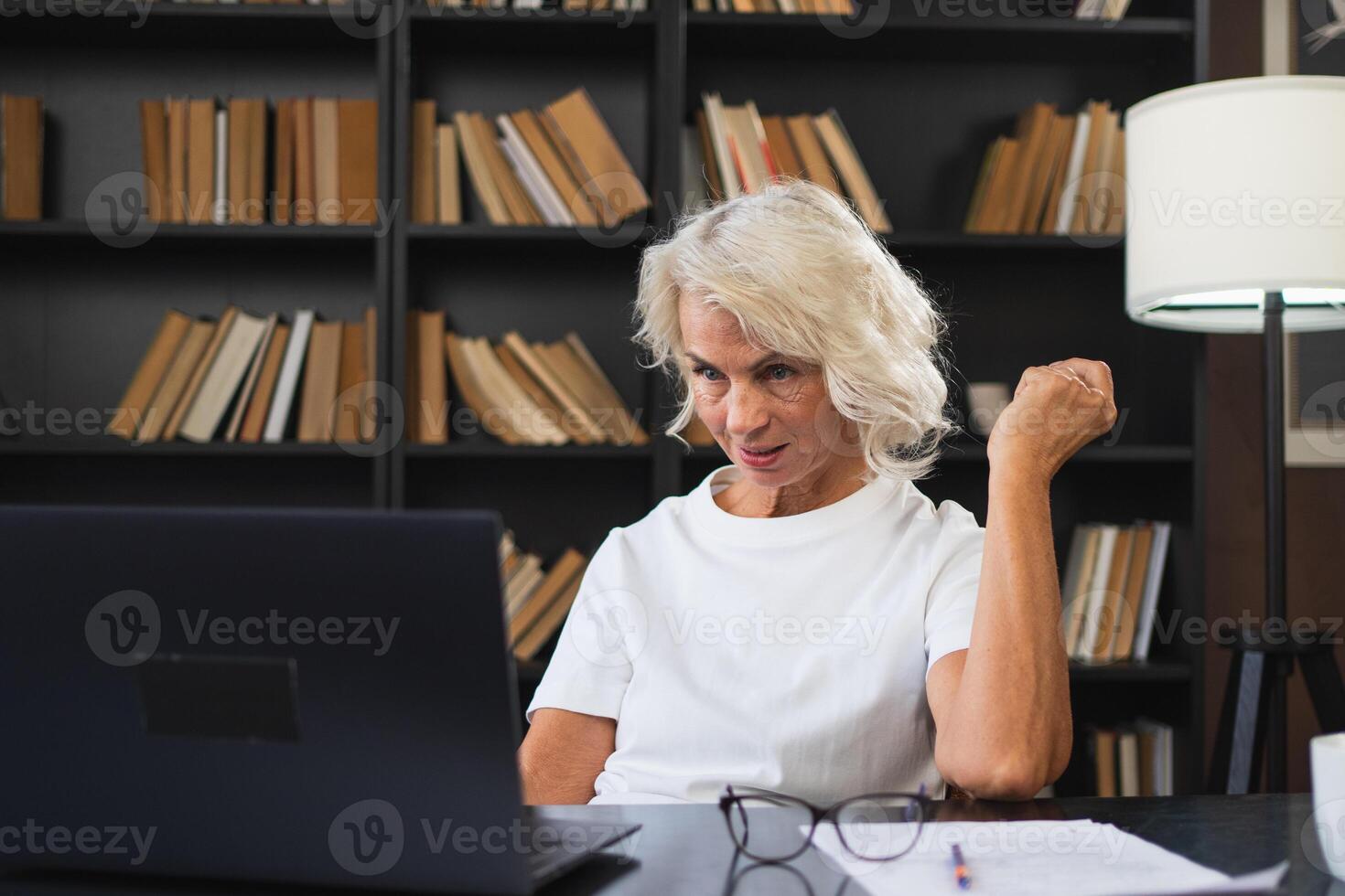 call. Happy middle aged senior woman sit with laptop talk on call. Mature old senior lady having fun talking speaking online. Older generation modern tech usage Virtual meeting online chat photo