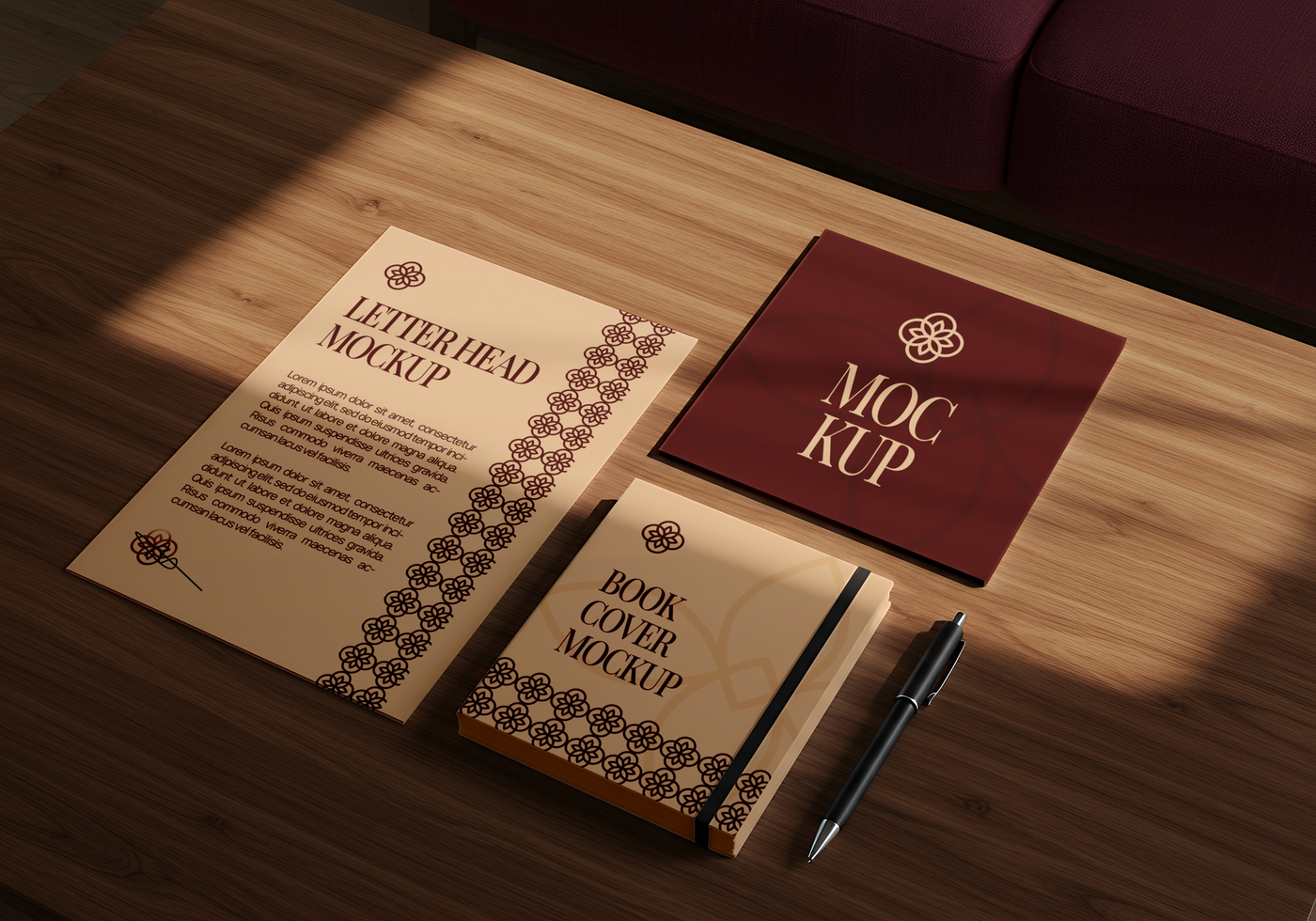 Elegant letterhead book cover and card mockups arranged on a wooden table with a pen psd