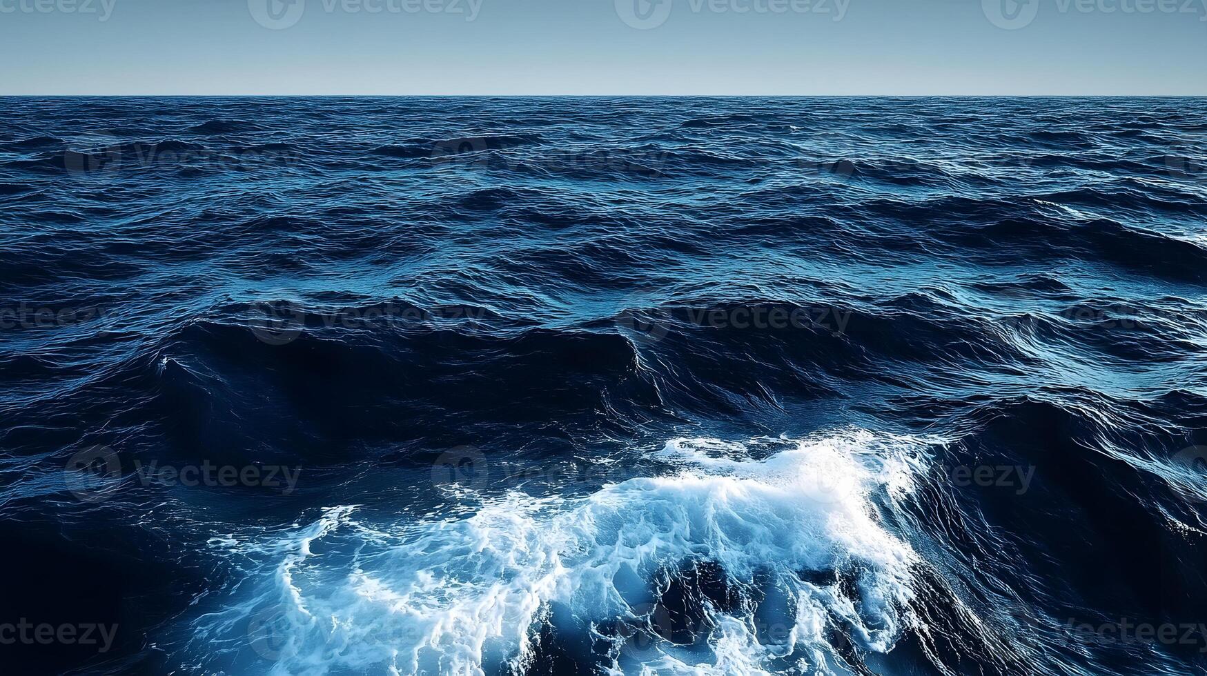 The ocean is seen from above with waves photo