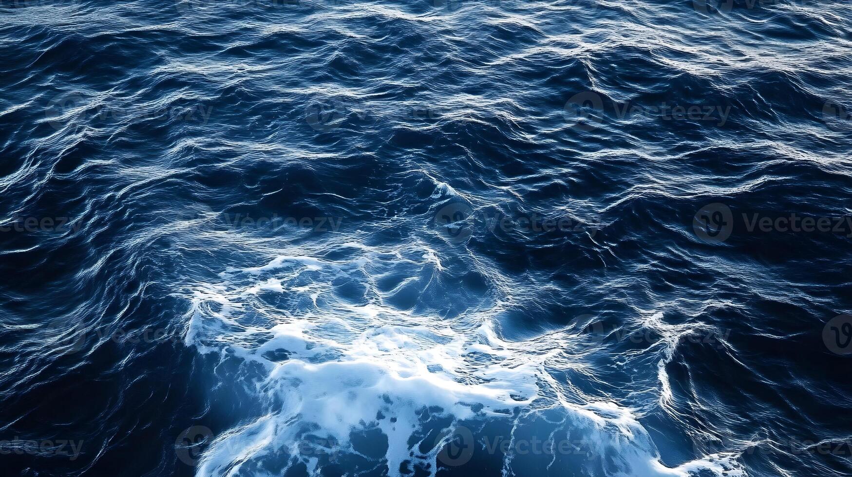 The surface of the ocean is covered with waves photo