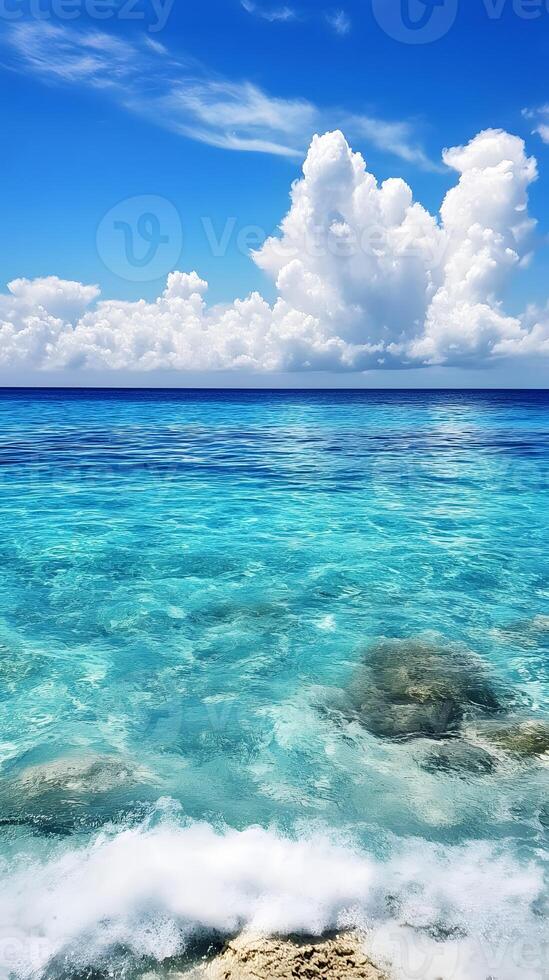 A beautiful blue ocean with white clouds and rocks photo