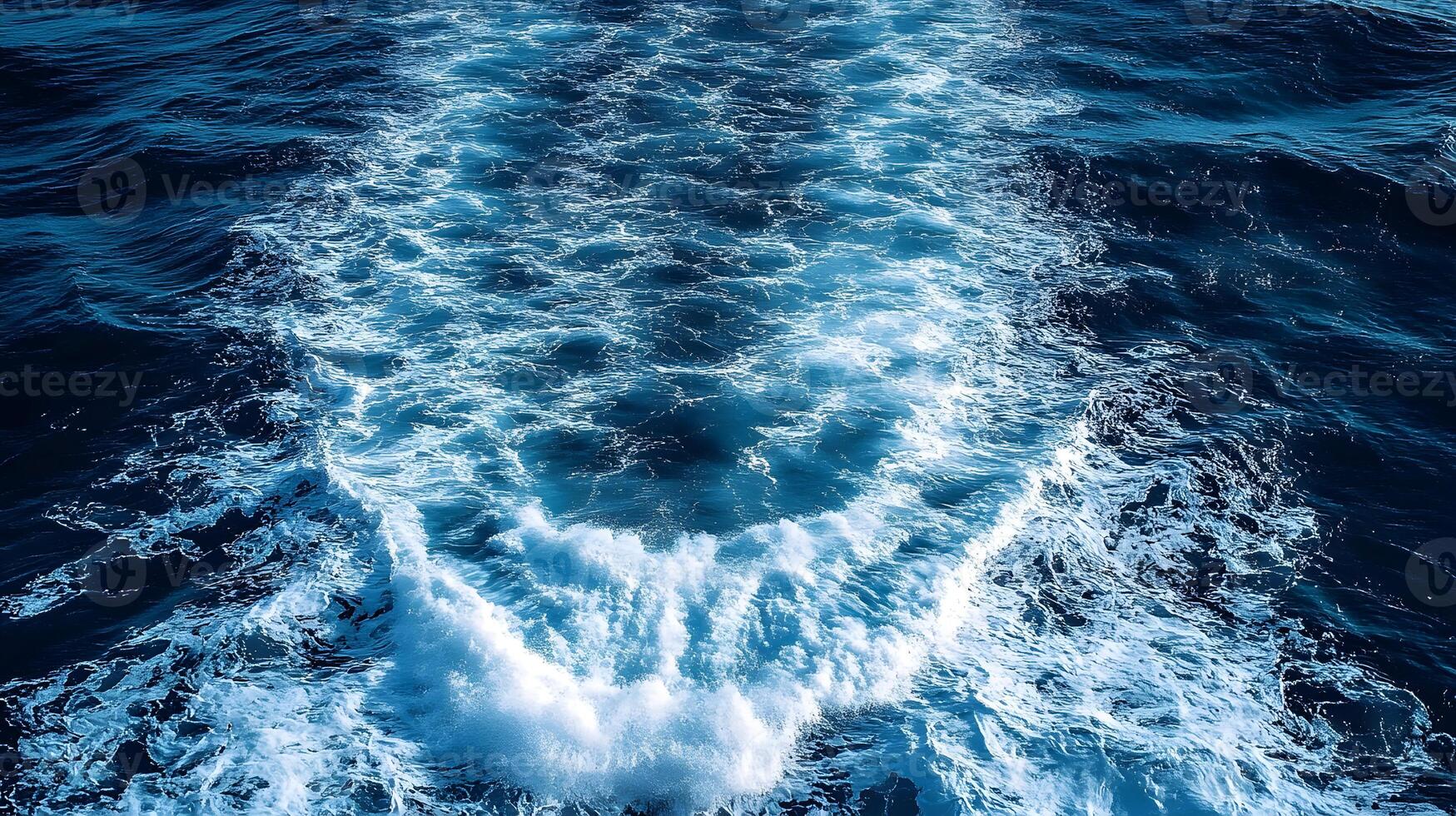 The wake of a boat in the ocean photo