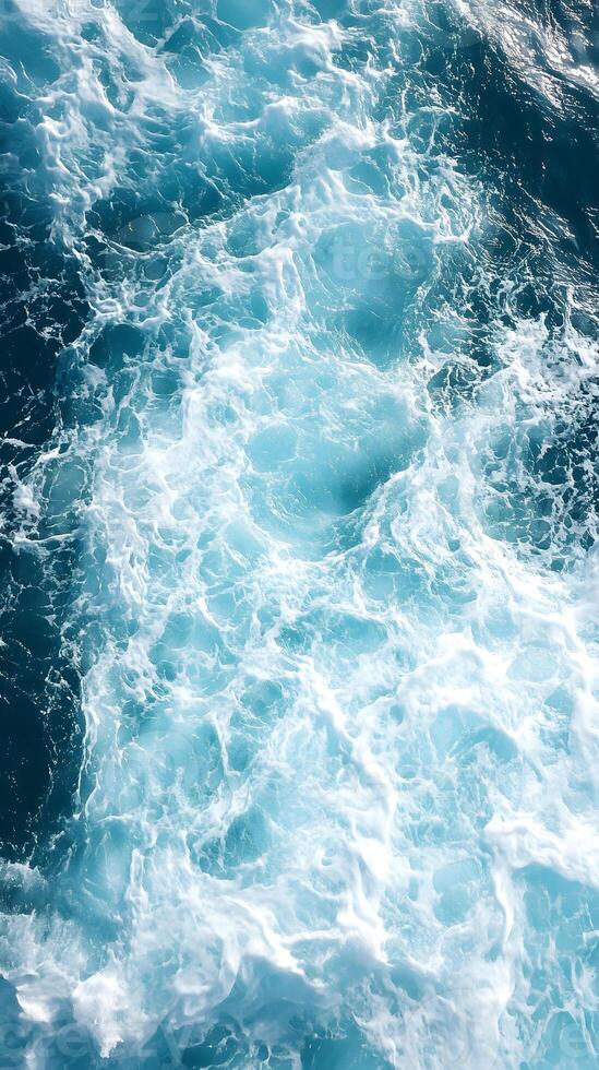 The ocean is blue and has white waves photo