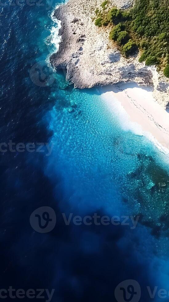 An aerial view of a beach and blue water photo