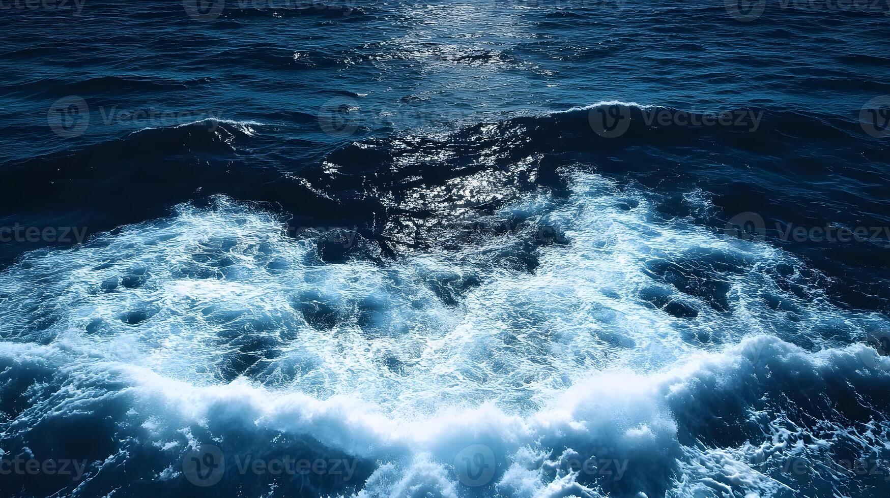 The ocean is seen from above with waves breaking photo