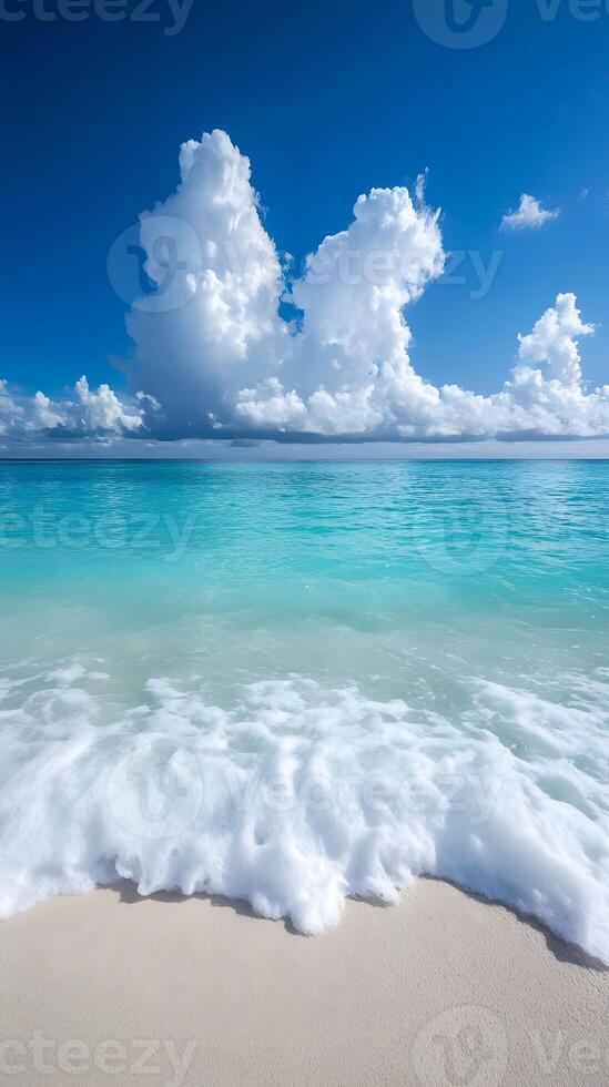 A beautiful beach with waves and clouds photo